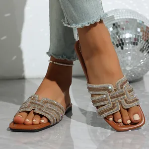 Stylish brown flat sandals with sparkling rhinestone geometric straps for women's summer wear.