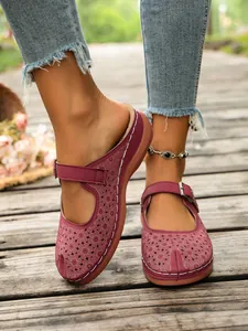 Elegant burgundy floral hollow-out wedge clogs with adjustable buckle strap for women.