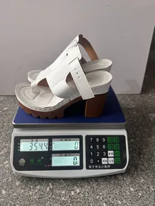 Λεπτομερής προβολή που δείχνει το βάρος 354g των λευκών πέδιλων πλατφόρμας στη ζυγαριά
