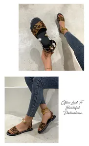 Fashionable leopard print flat sandals featuring a decorative pearl ankle strap.