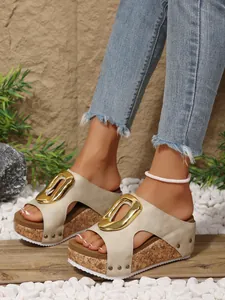 Detailed view of beige platform wedge sandals featuring a stylish gold buckle