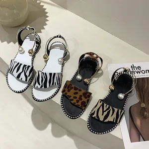 Fashionable flat animal print sandals for women with pearl and gold bead ankle straps