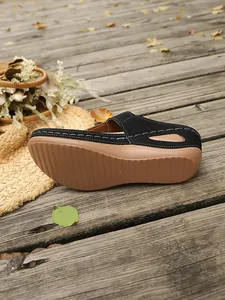 Detail shot of black wedge mule sandal showing the anti-slip sole and side profile.