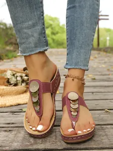 Wedge thong sandals with gold metallic sequins in burgundy color on wooden path