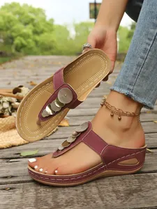 Maroon wedge thong sandals with gold sequin accents for beach wear