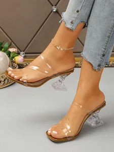 Close-up of elegant square toe transparent high heel sandals with clear straps