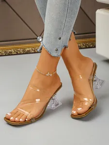 Detailed view of women's square toe mules with transparent straps and faceted clear heels.
