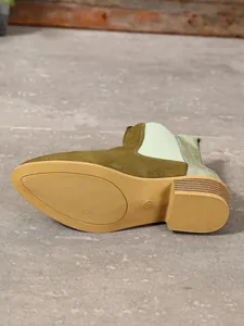 Close-up of olive green Chelsea boot sole showing size 37 and textured block heel