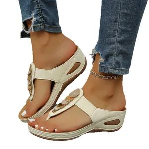 Stylish women's beige wedge thong sandals featuring decorative gold sequins and platform sole