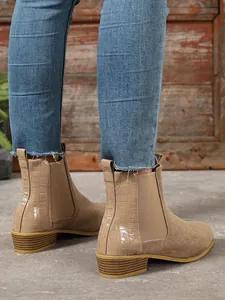 Detailed view of khaki frosted leather Chelsea boots with square heel and croco pattern