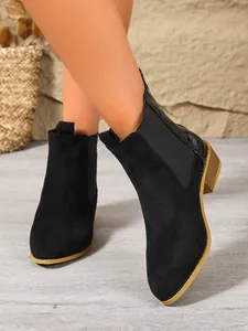Black suede Chelsea boots for women with pointed toe and comfortable low block heel.