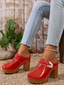 Red patent leather platform clogs with rivets and chunky high heels for women.