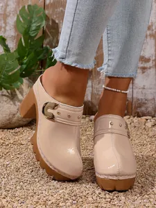 Beige patent leather platform mule heels with rivet buckle and chunky high heel