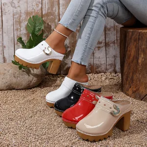 Stylish women's platform clog heels featuring gold rivets and a glossy patent finish