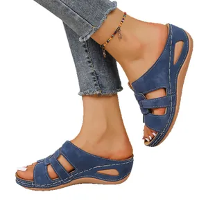 Élégantes sandales compensées bleues ajourées avec surpiqûres blanches pour femmes.
