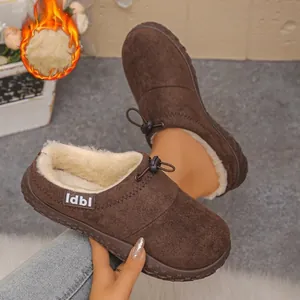 Detail of brown suede winter slippers with warm faux fur lining and drawstring