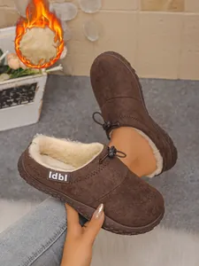 Cozy brown suede slippers with thick plush fur lining showing warmth-effect detail