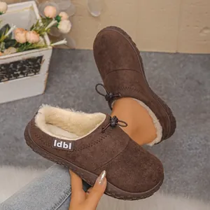 Close-up of brown suede slippers with soft white faux fur lining and adjustable drawstring