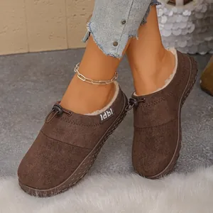 Close-up of brown suede slippers with cozy white fleece lining and drawstring detail