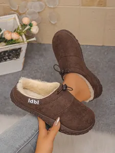 Macro view of brown suede plush clogs showing warm lining and adjustable drawstring