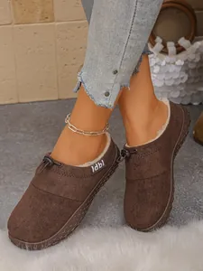 Close-up of brown suede loafers with plush lining and toggle drawstring detail