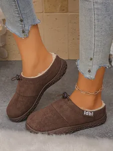 Detailed view of fashionable brown slip-on slippers with warm plush lining and Idbl label