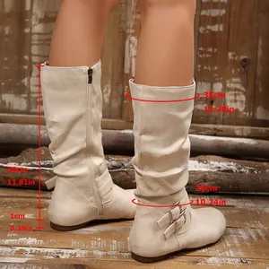 Detail of beige mid-calf boots with measurements, faux suede material with buckle straps