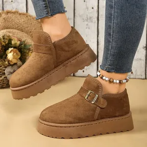 Primer plano de los zapatos de plataforma de gamuza marrón con hebilla ajustable