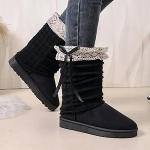 Stylish black winter boots with knitted shaft, lace trim and ribbon bow detail.