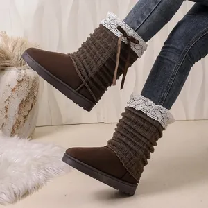 Close-up of stylish brown knit winter boots featuring white lace trim and cute bow detail