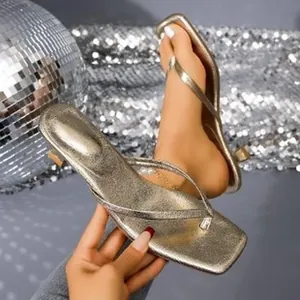 Stylish champagne gold metallic thong sandals with square toe and low kitten heel.