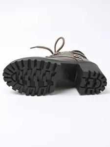 Bottom view of brown lace-up ankle boot showing high block heel and lug sole