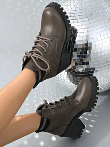 Stylish brown platform ankle boots featuring a lace-up design and ribbed knit collar detail