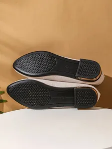 Detailed view of women's flat shoes with anti-slip rubber outsole and gold heel