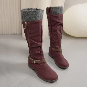 Stylish burgundy tall slouchy boots with grey knitted cuffs and elegant buckle details.