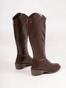 Rear view of brown knee-high Martin boots featuring a zipper closure and chunky heel