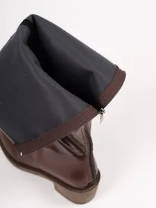 Close-up detail of brown leather Martin boots showing soft lining and back zipper closure