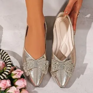 Elegant champagne pointed-toe flat shoes with glittery bow detailing