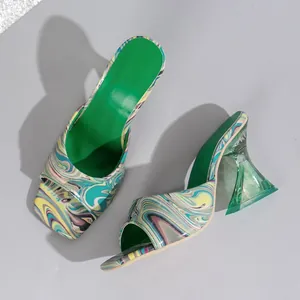 Detailed view of colorful marble pattern mules with clear green architectural heels