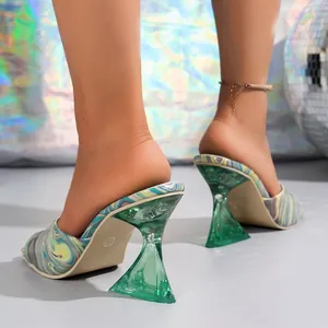 Detailed view of colorful square toe mules with transparent green geometric heels.
