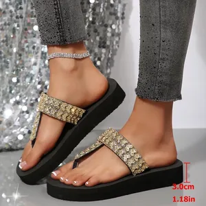 Detail view of black platform flip-flops with 3.0cm rhinestone-embellished straps