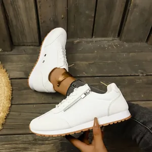 White women's casual sneakers with side zipper and classic brown rubber outsole detail