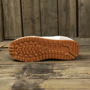 Detailed view of the brown textured non-slip gum outsole on women's sneakers