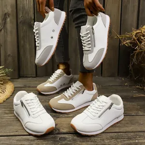Casual white women's sneakers with grey accents and side zipper detail