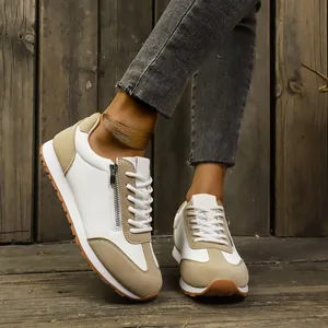Stylish women's white and beige casual sneakers with side zipper detail and mesh fabric.