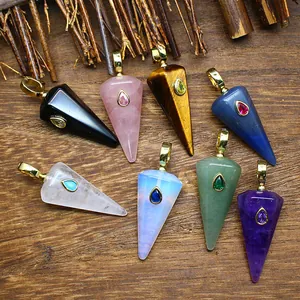 Close-up view of various natural stone hexagonal cone pendants with crystal inlays