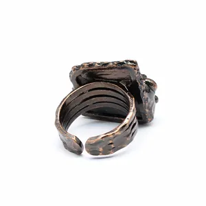 Detailed back view of a vintage distressed bronze adjustable ring with a unique textured band