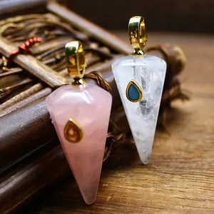 Close-up of hexagonal cone pendants made of rose quartz and clear quartz stones.