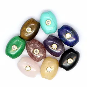 Macro detail of various natural stone barrel beads with sparkling inlaid cubic zirconia.