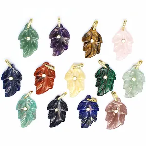 Collection of various small natural stone leaf pendants with gold zircon inlay details.